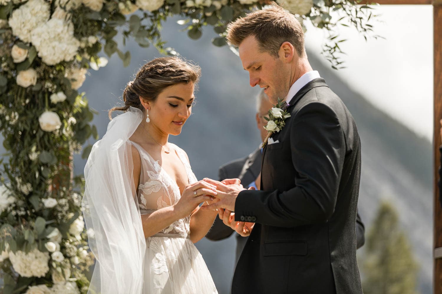 bride putting on wedding ring